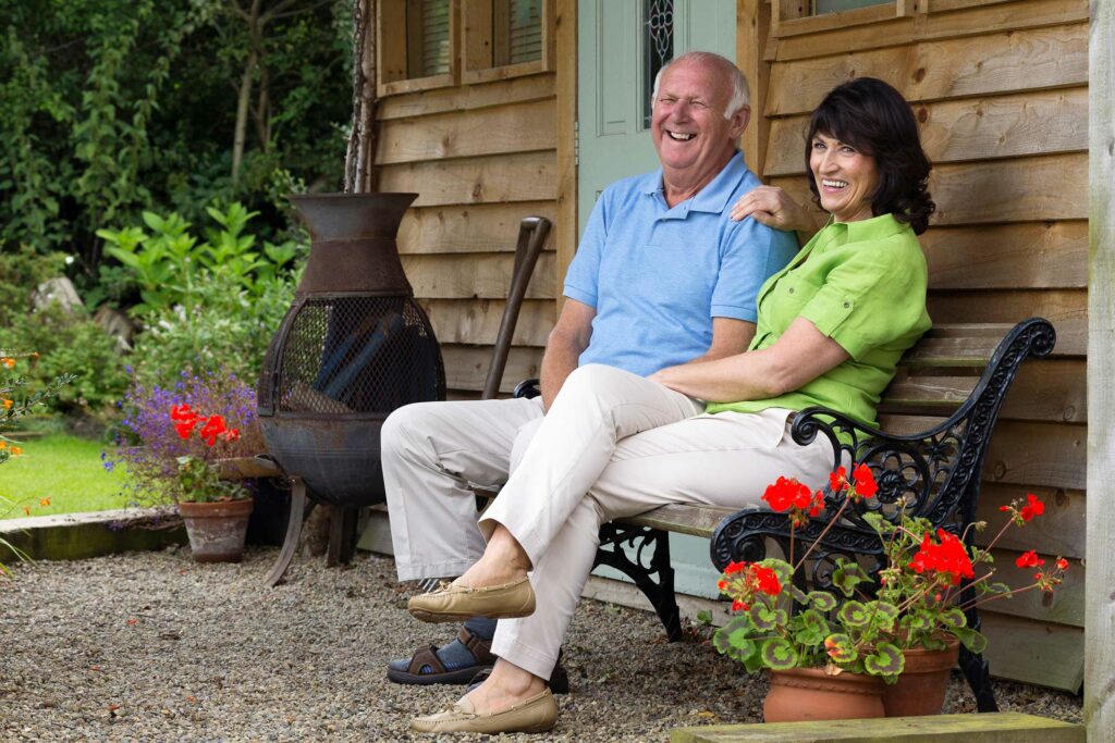 caretaker and person sitting on bench